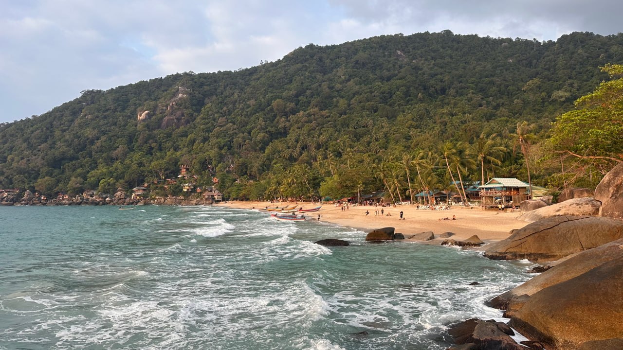 A beach and forested hillside on Koh Phangan, Thailand